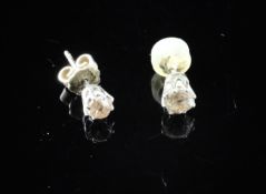Two solitaire diamond ear studs, set with old cut stones (different sizes).