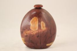 A Chinese jasper pebble snuff bottle, the reddish brown stone with cream and brown inclusions, 7cm.