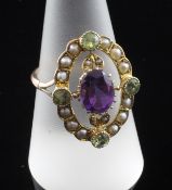 An early 20th century 9ct gold, amethyst, peridot and seed pearl set dress ring, of pierced oval