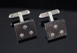 A pair of 18ct white gold and diamond cufflinks, of square form, each set with three diamonds on a