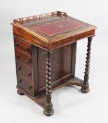 A Victorian rosewood davenport, with pierced three quarter gallery back, the lid inset with