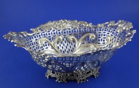 A Victorian pierced silver fruit bowl, of shaped oval form, with foliate scroll border with masks