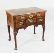 An 18th century mahogany lowboy, fitted an arrangement of five drawers and lappet carved pole legs