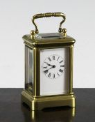 A Henri Jacot gilt brass miniature carriage timepiece, with enamelled dial no.9308, 3in.