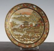 A Japanese Satsuma pottery dish, Meiji period, finely painted with a festival scene of figures in a