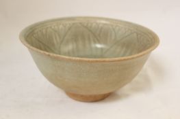 A Thai Sawankhalok celadon deep bowl, 14th / 15th century, incised in the interior with a
