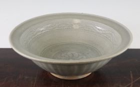 A Thai Sawankhalok celadon bowl, 14th / 15th century, the mouth rim everted, the cavetto with a