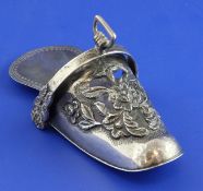 A continental white metal wall pocket, modelled as a slipper, with floral decoration, stamped 925,