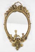 A 19th century oval giltwood and gesso girandole mirror, with ribbon crest and three scrolling