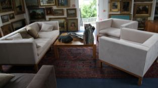 A De La Espada three piece suite, comprising a large settee and a pair of armchairs, with light oak
