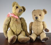 Two early 20th century English teddy bears, both bears straw filled, plush covered and swivel