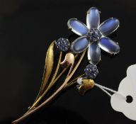 A two colour 14ct gold, moonstone and gem set brooch modelled as a flower, 3in.