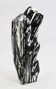 An elongated Javanese petrified wood specimen, displaying a striking palette of mottled greys and
