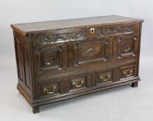 A late 17th century carved and panelled oak marriage chest, engraved with initials `I R`, two base