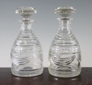 A pair of Regency mallet shaped decanters and stoppers, with stepped diamond and swag cut bands,