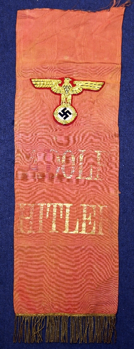 A German Third Reich silk banner, marked Adolf Hitler and stitched with an eagle swastika badge,