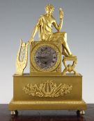 An early 19th century French ormolu mantel timepiece, surmounted with a figure of a classical