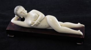 A Chinese ivory medicine figure of a reclining lady, first half 20th century, 18cm., wood stand