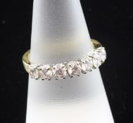 An 18ct gold and seven stone diamond half hoop ring, the diamonds with a total approximate weight