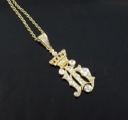 A high carat gold and diamond set drop pendant, modelled and a monogram? beneath a coronet, with an