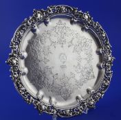 A Victorian silver salver, of shaped circular form, with engraved monogram and pierced cast border