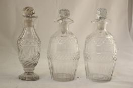 A pair of Regency cut glass decanters and stoppers, and a similar oil or vinegar bottle, the pair