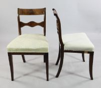 A set of six Regency boxwood line inlaid mahogany dining chairs, with curved crest rails, pierced