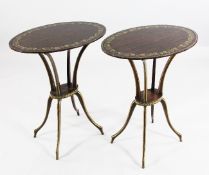 A pair of simulated and parcel gilt oval occasional tables, on shaped supports and scrolling legs,