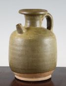 A Chinese olive green glazed pottery ewer, Tang Dynasty, unglazed base, 18cm.