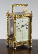 An Edwardian gilt brass carriage alarum clock, with enamelled dial and movement striking on a bell,