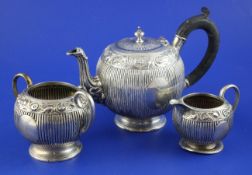 A Victorian silver three piece bachelors tea set by Charles Stuart Harris, of spherical form, with