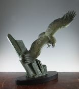 A French Art Deco bronzed metal model of an eagle in flight, signed Rulas, on black marble plinth,