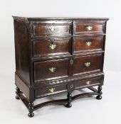 A late 17th / early 18th century oak chest on stand, fitted with an arrangement of six drawers,