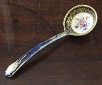 A Worcester moulded sauce ladle, c.1770, the dark blue ground decorated with painted floral sprays