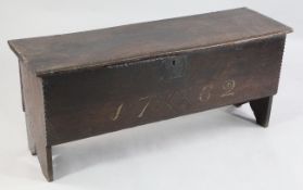 An 18th century oak six plank coffer, the front engraved with initials and with the painted date