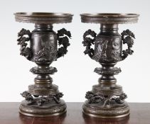 A pair of Japanese bronze vases, Meiji period, finely cast in relief with immortals, dragons and