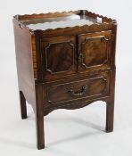 A George III mahogany night cupboard, the tray top with wavy gallery over two drawers and single