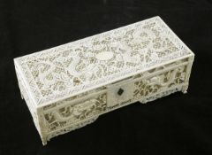 A Chinese ivory `dragon` rectangular box, late 19th / early 20th century, carved and pierced with