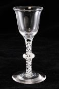 A mixed twist wine glass, c.1760, the funnel shaped bowl set on a double series opaque tape stem,