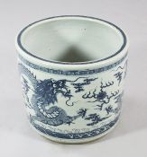 A Chinese blue and white `dragon` jardiniere, painted with two confronting dragons chasing a