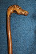 A small walking stick, probably sycamore, the handle carved as a horse`s head with inset glass eyes,