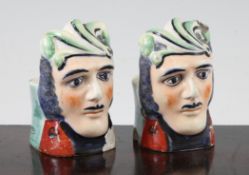 A pair of Staffordshire sash window rests, late 19th century, each modelled as the head of a