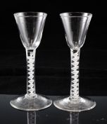 A pair of George III opaque twist stem drinking glasses, c.1760, the funnel shaped bowls set on