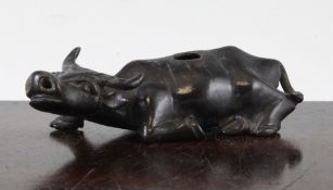 A Chinese bronze water dropper, in the form of a recumbent buffalo, 17th / 18th century, 13.5cm.