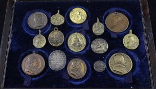 A collection of 18th and 20th century bronze and copper papal medallions, together with Royal