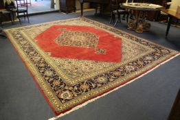 A north west Persian carpet, with central stepped foliate medallion, on a red ground with