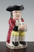 A Davenport Hearty Goodfellow pottery Toby jug, c.1840, the seated figure wearing a maroon coat