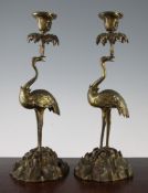 A pair of 19th century ormolu stork candlesticks, on domed rocky bases, 15.25in.
