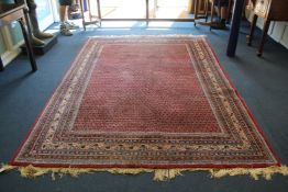 A Saraband carpet, with extensive field of pears on a red ground, with seven row border, 9ft 2in