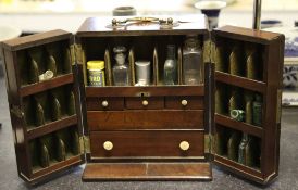 A George III mahogany travelling apothecary`s chest, the two doors opening to reveal pigeon holes,